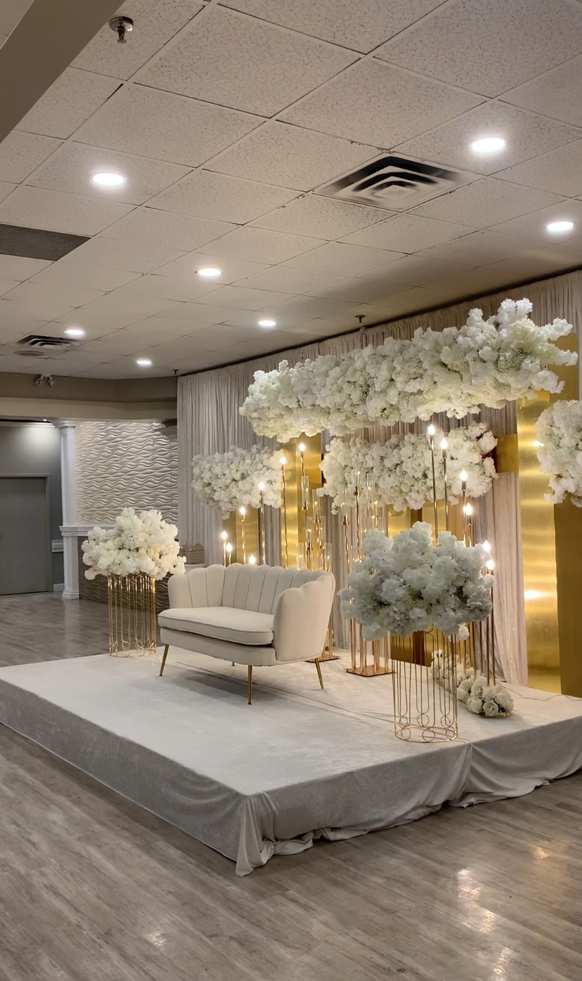Babylon Banquet Hall decorated with white flowers and gold candles